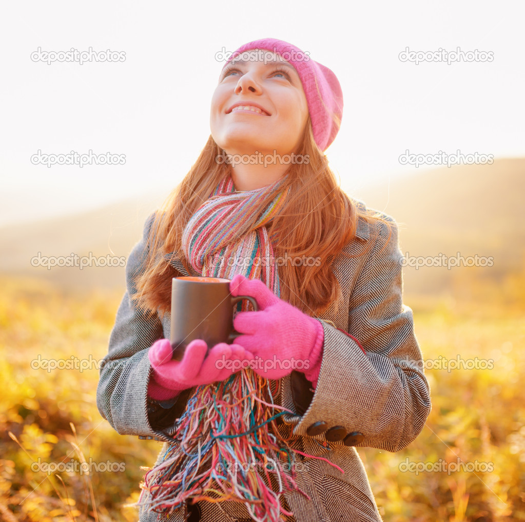 Young woman enjoying the fall season. Autumn outdoor portrait