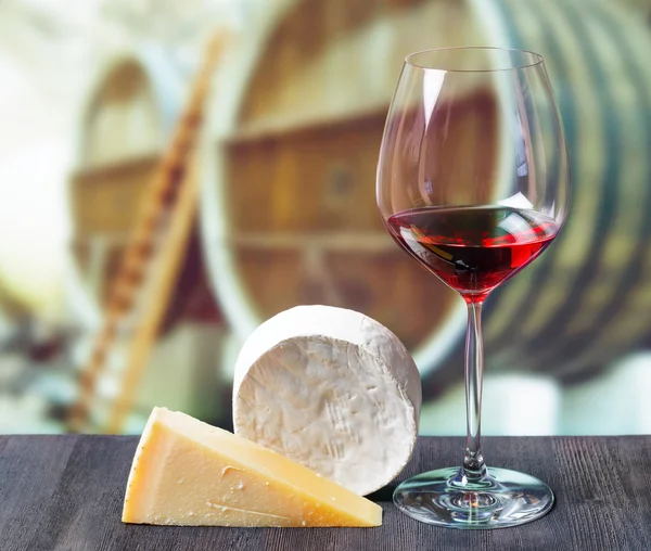 Glass of wine and cheese in winery — Stock Photo, Image