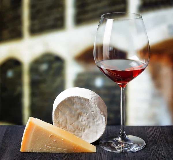 Glass of wine and cheese in winery — Stock Photo, Image