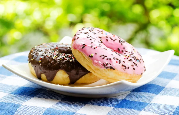Fresh donuts on nature background — Stock Photo, Image