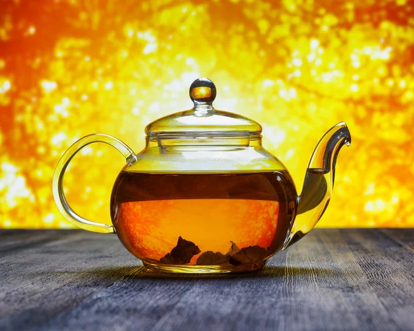 Teapot of fresh tea on sky background — Stock Photo, Image