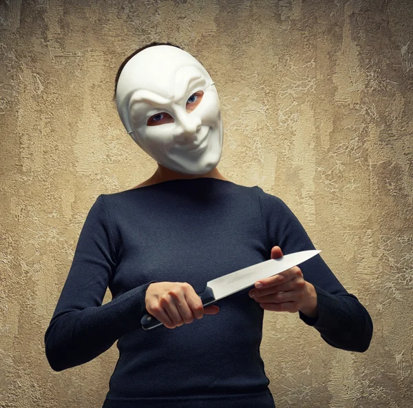 Woman in white mask holding the knife — Stock Photo, Image
