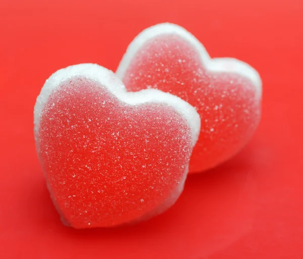 Sugar hearts on red background — Stock Photo, Image