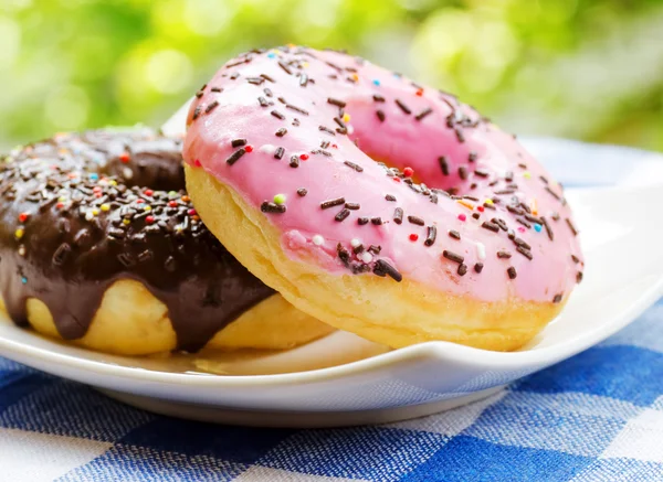 Fresh donuts on nature background — Stock Photo, Image