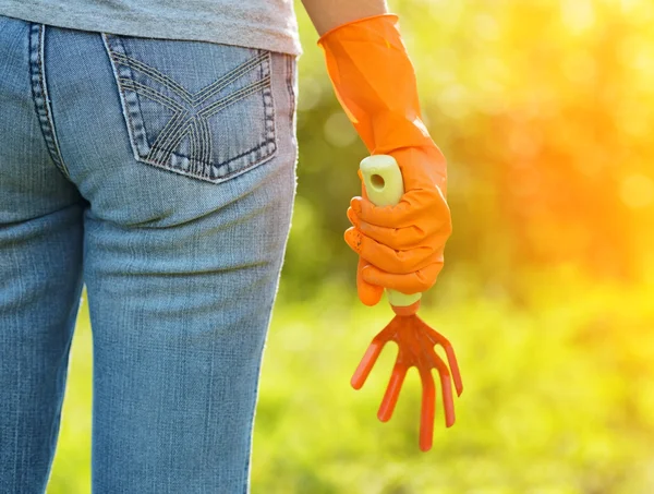 Frau in orangefarbenen Handschuhen arbeitet im Garten — Stockfoto