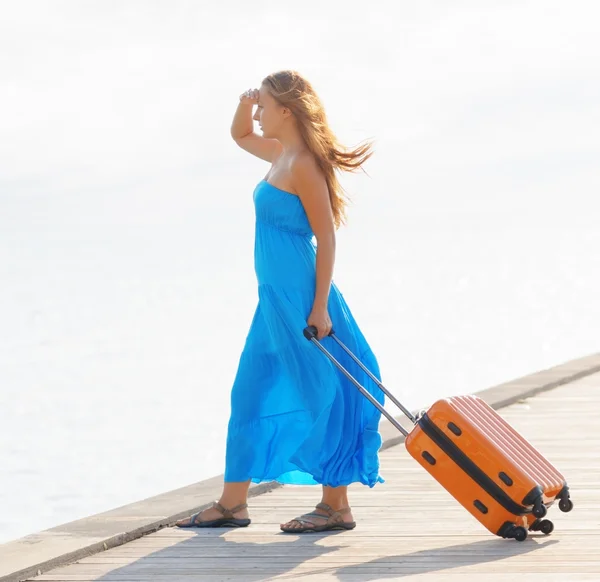 Młoda kobieta z walizką na molo — Zdjęcie stockowe