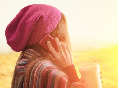 bir bardak kahve tutan genç kadın. Açık dikey