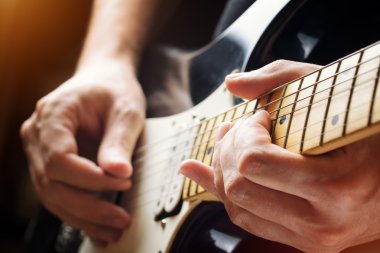 Man playing guitar. Close-up view