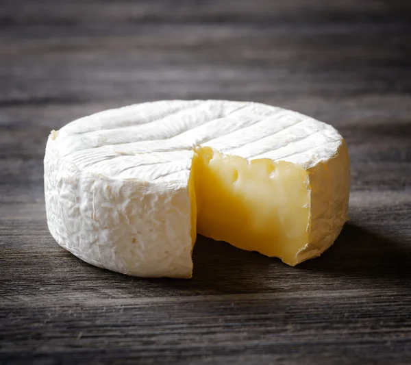 Camembert cheese on a wooden board — Stock Photo, Image