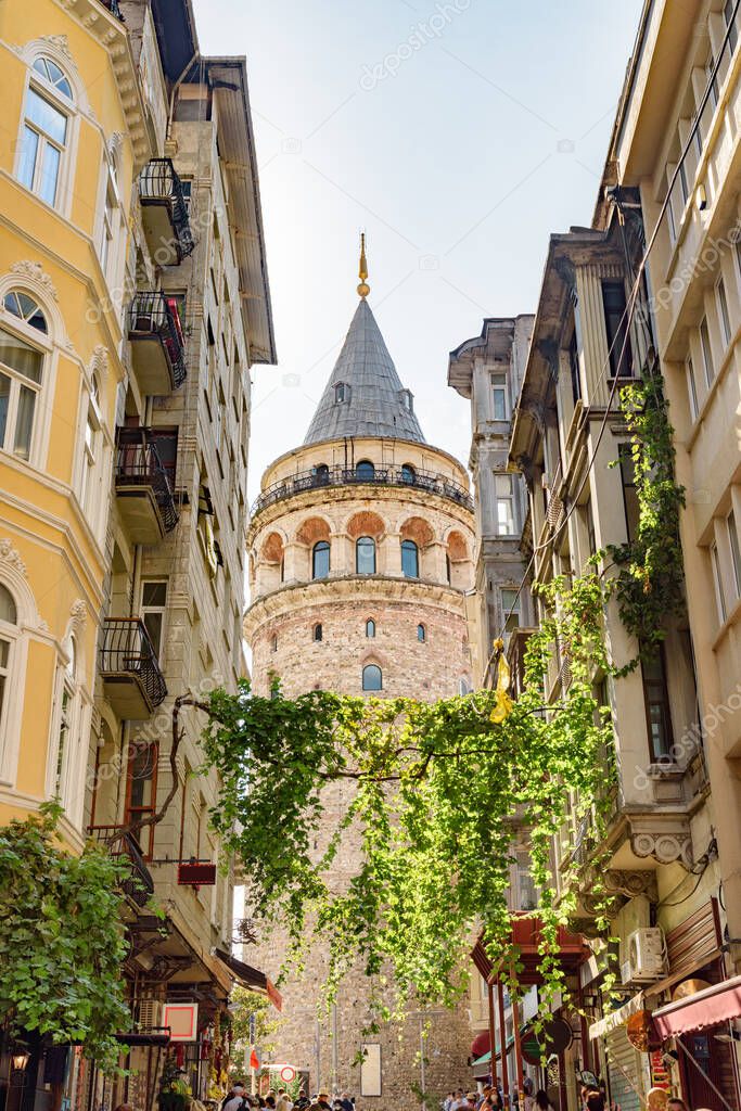 View of the Galata Tower from an old narrow street. Istanbul is a popular tourist destination in the world.