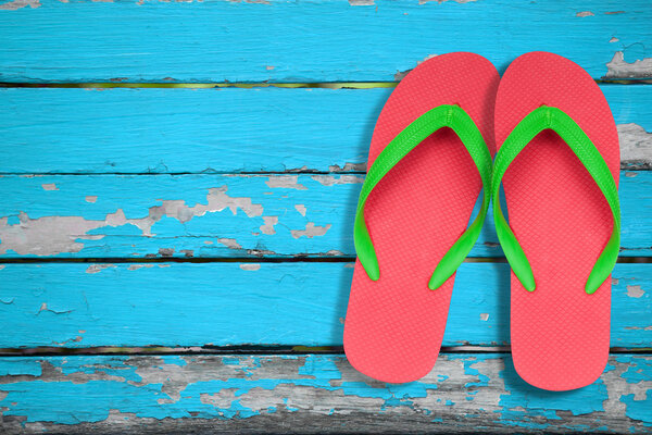 red ang green flip flop sandals on blue wood