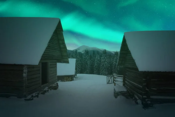 Fantastisch winterlandschap met houten huizen in besneeuwde bergen — Stockfoto