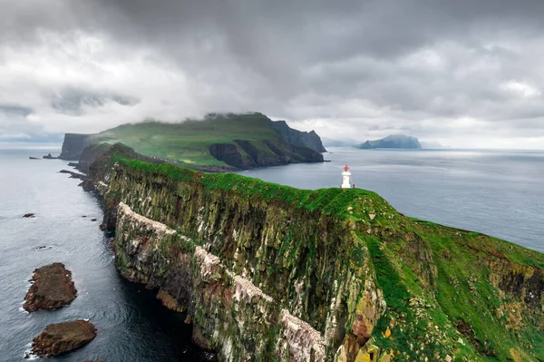 Foggy view of old lighthouse on the Mykines island — Stock Photo, Image