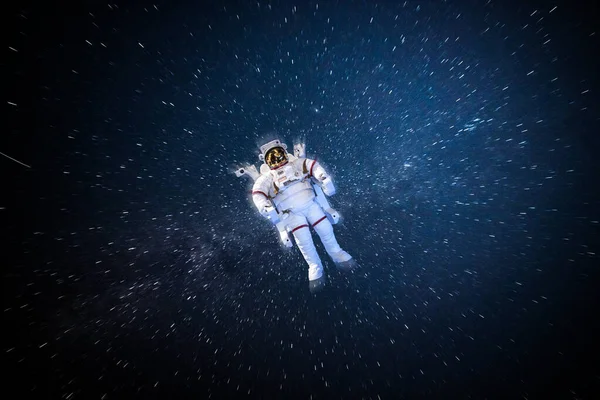 Astronaut spaceman in outer space in full spacesuit on stars sky background — Stock Photo, Image