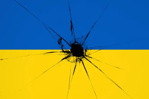 Ukraine blue and yellow bicolor flag with a hole from a shot — Stock Photo, Image