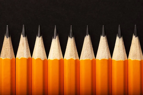 Abstract Background Orange Pencils Lying Row Black Background Colour Concept —  Fotos de Stock