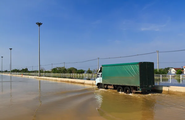 Goods truck on flooded road — Stock Photo, Image