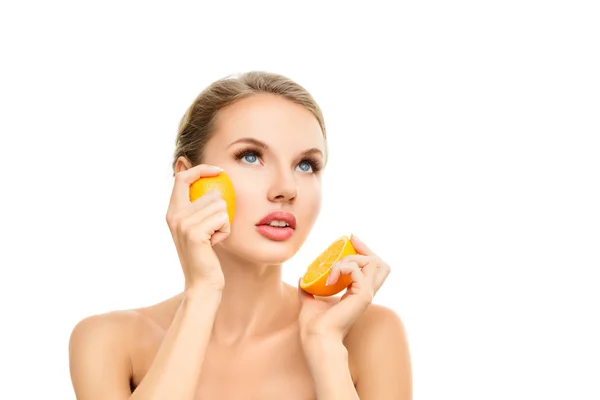 Young woman with orange in her hands — Stock Photo, Image