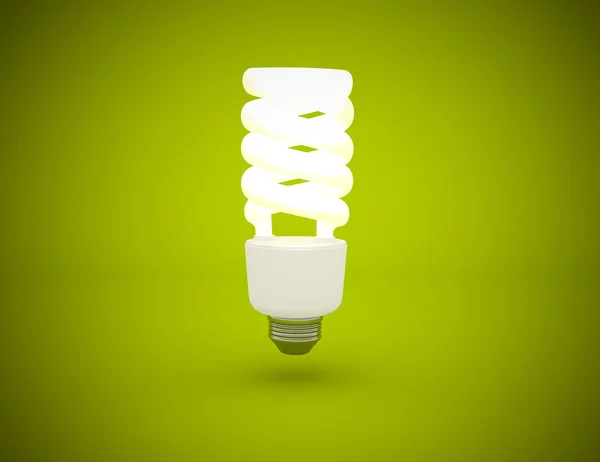 Light bulb lit on green background — Stock Photo, Image