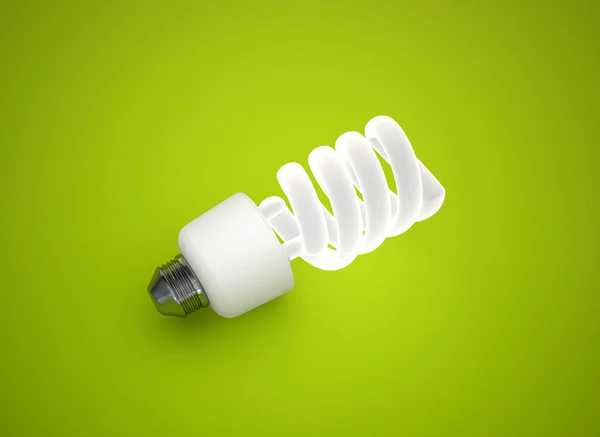 Energy saving light bulb on green background — Stock Photo, Image