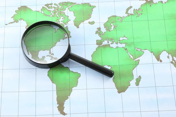 Magnifying glass black frame on world map paper.