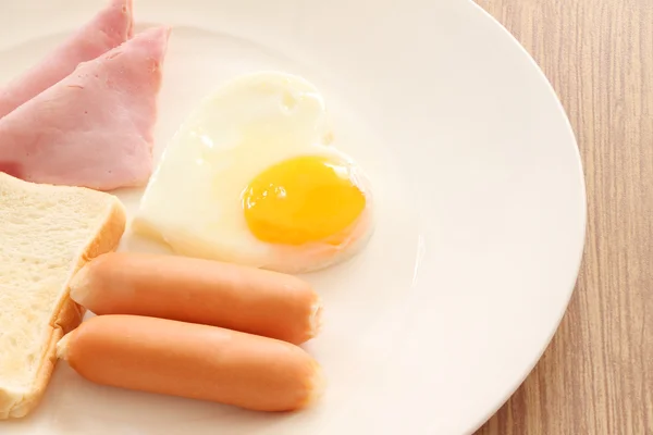 Part of fried egg with bacon dish breakfast on white background. — Stock Photo, Image