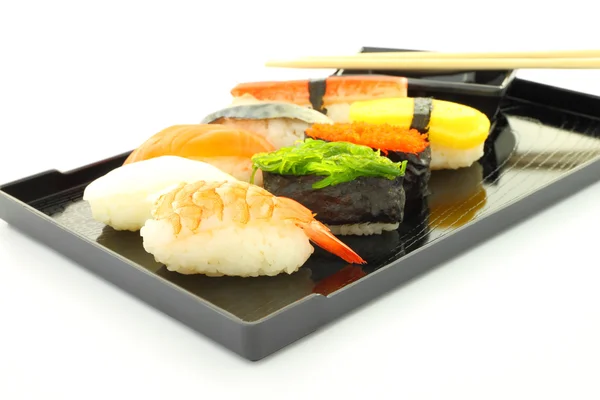 Sushi black rectangle plate focus shrimp on white table. — Stock Photo, Image