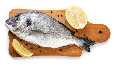 Mutfak tahtasında limonlu çiğ Dorado beyaz arka planda yakın plan. İzole edilmiş