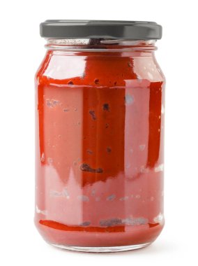 Tomato paste in a glass jar close-up on a white background. Isolated