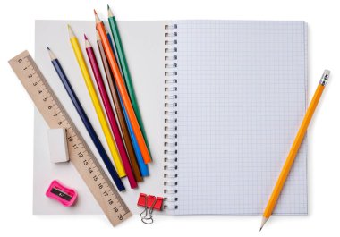 School notebook with colored pencils and a ruler close-up on a white background. Top view. Place for text.