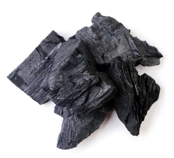 Pile of charcoal close-up on a white background. Top view.