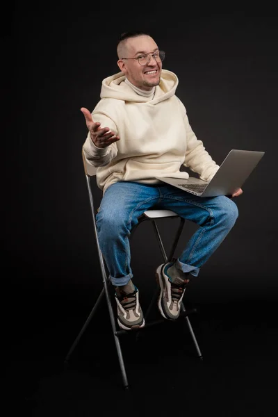 Joven hombre de negocios feliz con un cuaderno aislado sobre fondo negro. Enfoque selectivo, sujeto principal - hombre. Interesante concepto de negocio. —  Fotos de Stock