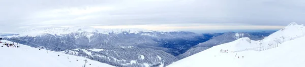 Panoramic winter landscape: The Rosa Khutor Alpine Resort near Krasnaya Polyana panoramic background. — ストック写真