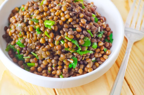 Lentils in a white bowl — Stock Photo, Image