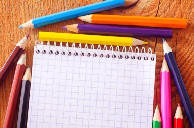 Renkli kalemler ve bir defter.