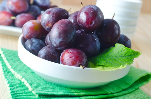 Plum in a white bowl — Stock Photo, Image