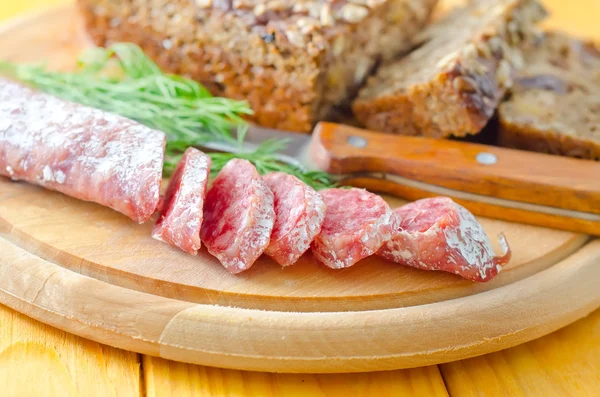 Salami on a wooden board — Stock Photo, Image