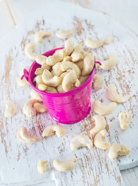 Cashew nuts in a pink bucket — Stock Photo, Image