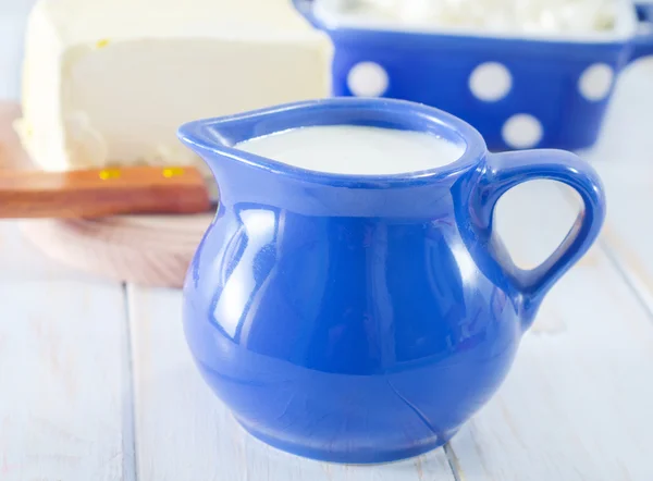 Milk in blue jug — Stock Photo, Image