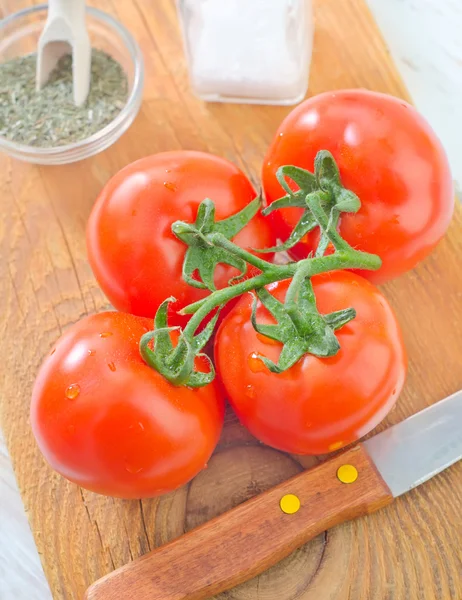 Tomato on a wooden board — Stock Photo, Image
