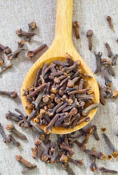 Cloves in a wooden spoon — Stock Photo, Image