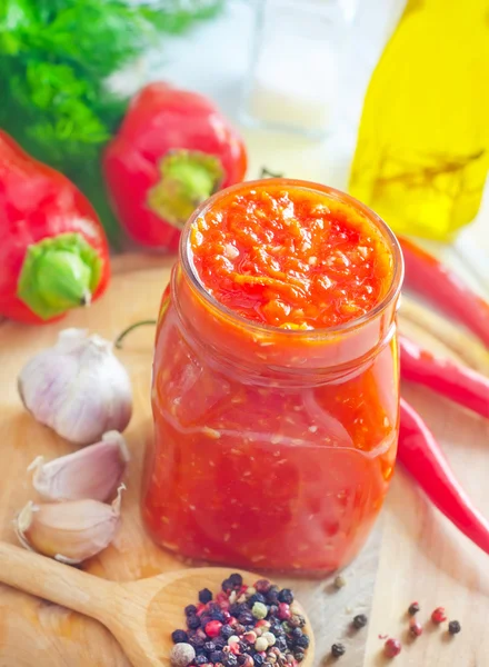 Fresh chilli sauce in the glass bank — Stock Photo, Image