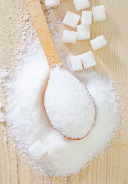 Sugar in a wooden spoon — Stock Photo, Image