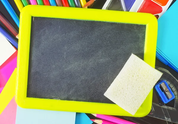 Blackboard and school supplies — Stock Photo, Image