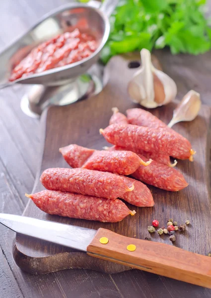 Sausages on a wooden board — Stock Photo, Image