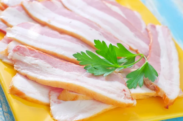 Smoked bacon on plate — Stock Photo, Image