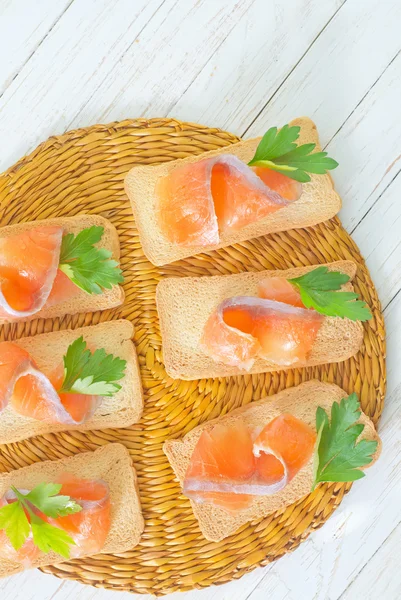 Toasts with salmon and parsley — Stock Photo, Image