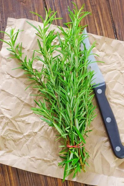 Rosemary on a wooden table — Stock Photo, Image