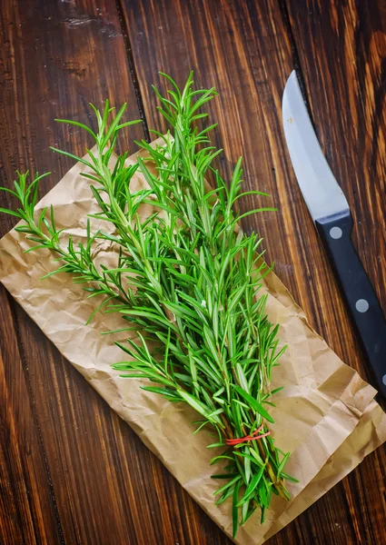 Rosemary on a wooden table — Stock Photo, Image