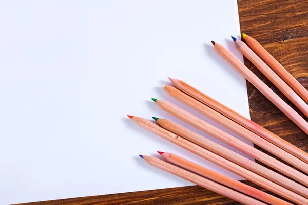 Paper and colored pencils — Stock Photo, Image